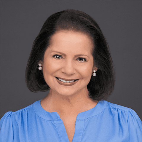 Headshot of Susan Enfield; smiling dark-haired woman on grey background